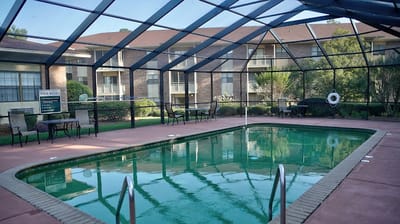 Outdoor pool area with seating and landscaping