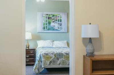 Interior view of a cozy resident room with bedside lamp