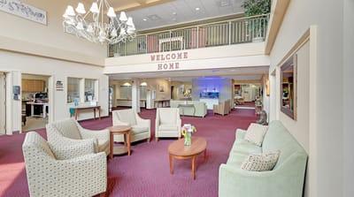 Bright common area with seating and a welcoming sign