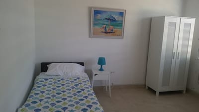 Bright and simple resident room with beach-themed decor