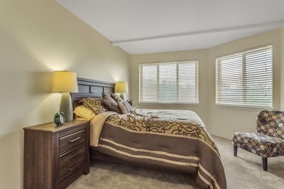 A cozy private bedroom with a bed and natural light