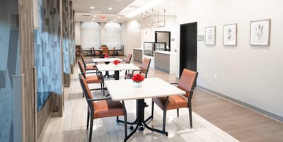 Bright dining area with tables and flowers