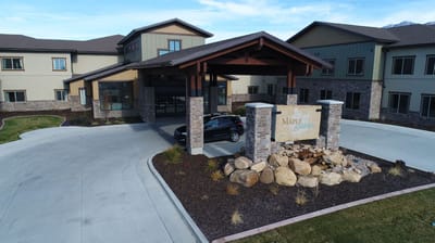 Entrance of Maple Springs facility with stone signage and landscaping