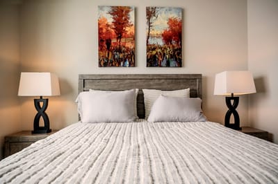 Cozy bedroom setup with art and lamps