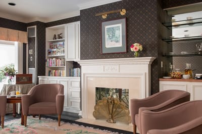 Cozy common area with a fireplace and bookshelves