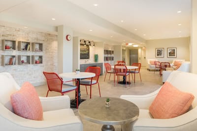 Bright common area with seating and bookshelves