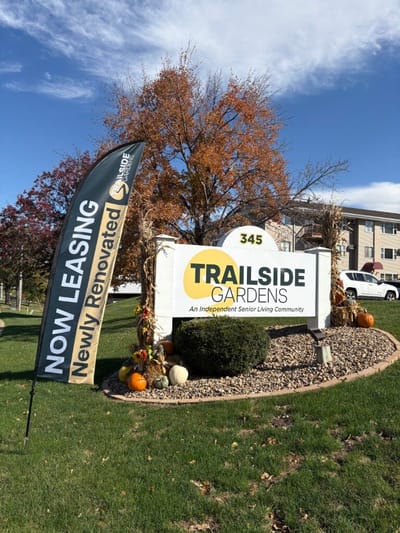 Exterior view of Trailside Gardens sign with fall decorations