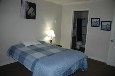 Cozy private room with a bed and artwork