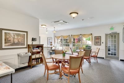 Bright common area with a round table and chairs