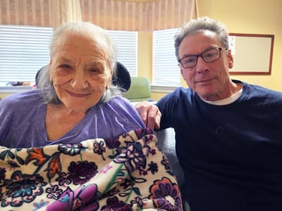 Resident and visitor sharing a moment indoors