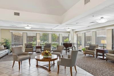 Bright interior common area with seating and piano