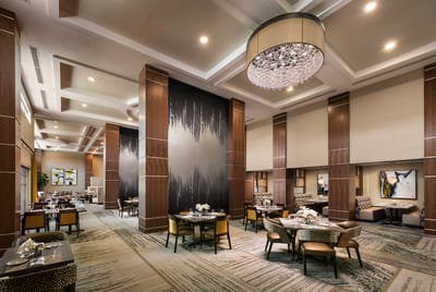 Elegant dining room setup with tables and chandeliers