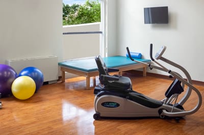 Interior view of a fitness room with equipment and exercise balls