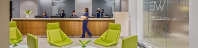 Bright reception area with staff and modern seating