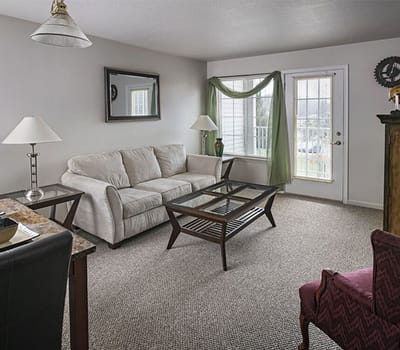 Cozy living room area with a couch and natural light