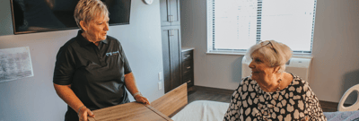 Staff member interacting with a resident in their room
