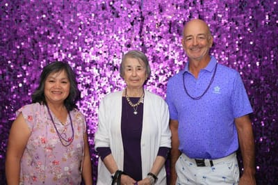 Three residents smiling at a celebration event