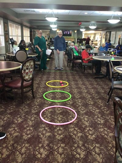 Residents engaging in a fun indoor activity with hoops