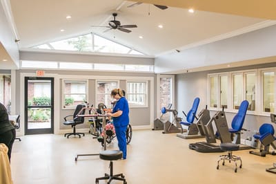 Interior view of a therapy room with staff and equipment