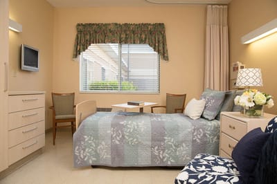Cozy resident room with a bed and seating area