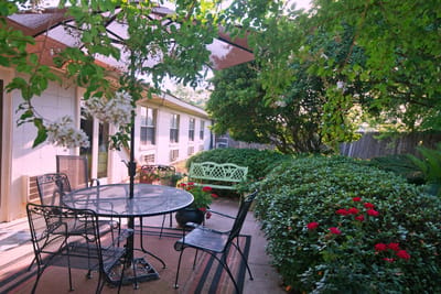 Outdoor patio with seating and lush greenery