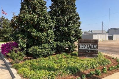 Signage for Roseview Nursing & Rehabilitation Center surrounded by greenery