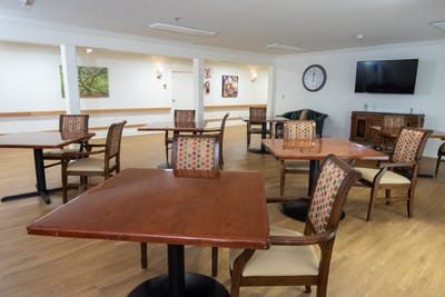 Dining area with tables and chairs in a common room