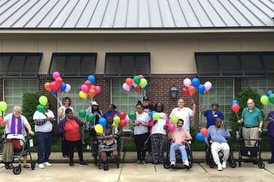 Residents celebrating outside with balloons