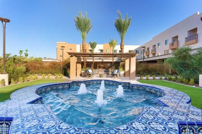 Beautiful outdoor pool area with lush landscaping