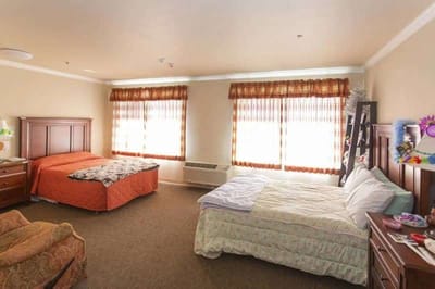 Interior view of a resident room with beds and furniture