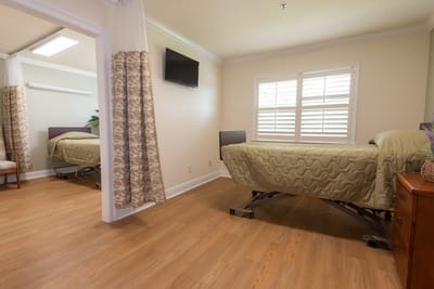 Private resident room with a bed and a window