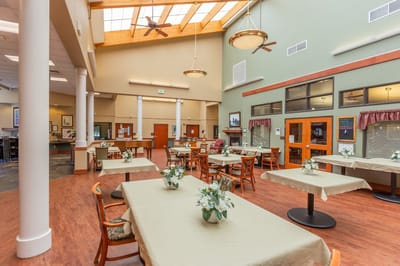 Bright dining area with tables and floral centerpieces