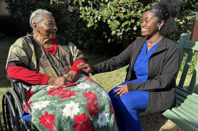 Resident and staff member enjoying time outdoors