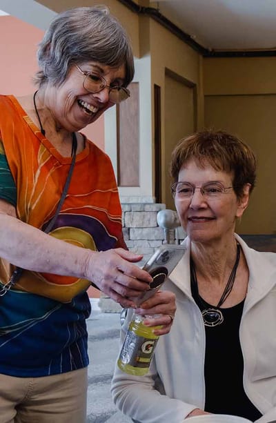 Two women enjoying a moment in a common area