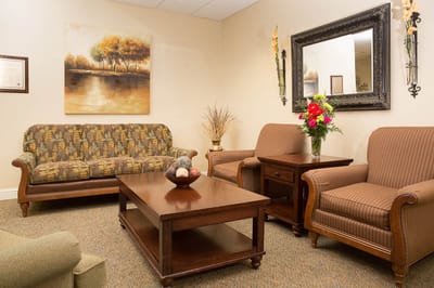 Cozy lounge area with seating and floral decor