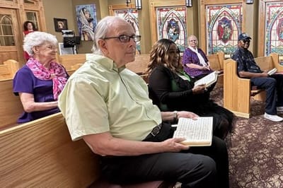 Residents and staff attending a gathering in the chapel