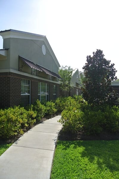 Pathway leading to the facility with landscaped surroundings