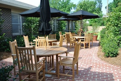 Outdoor seating area with wooden tables and umbrellas