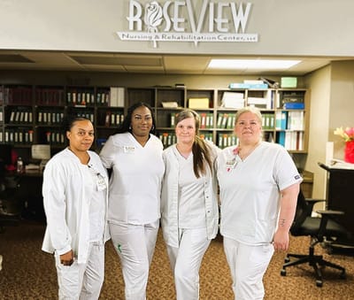 Staff members posing in the facility lobby
