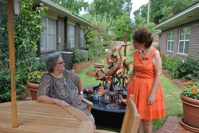 Residents enjoying a garden fountain in a communal outdoor space