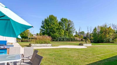 Spacious outdoor area with green grass and trees