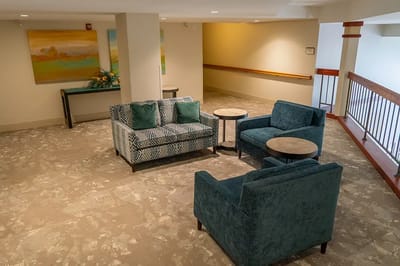 A cozy common area with seating and art