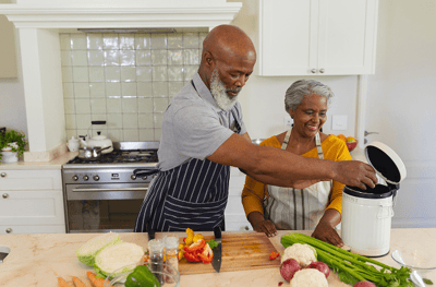 A senior couple cooking together in a kitchen
