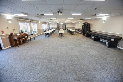 Common area with tables and chairs set up for activities