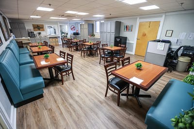 Dining area with tables and seating in a senior living facility