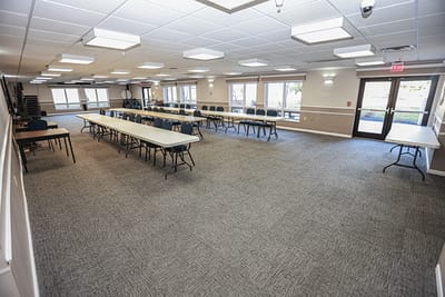 Interior view of a community activity room with tables