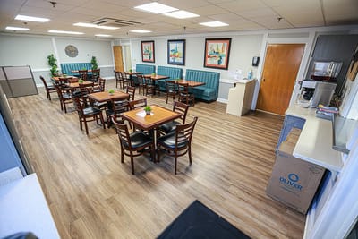Bright dining area with wooden tables and chairs