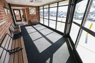 A bright entrance area with seating and large windows
