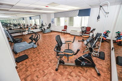 Fitness area with exercise equipment in a bright room