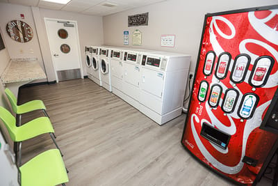 Laundry room with washing machines and a vending machine